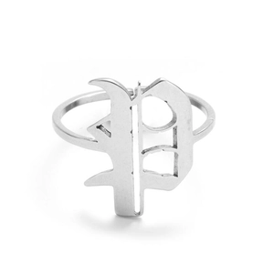Detailed macro view of vintage silver ring with gothic letter P and intricate filigree