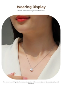 Close-up of 925 silver snowflake necklace featuring sparkling moissanite on a model