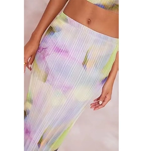 Detail of pleated maxi skirt featuring a soft pastel gradient and elastic waistband