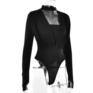 Detail of V-neck ruching and slim fit texture on a long sleeve black bodysuit