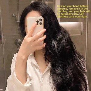 Detailed view of natural black long wavy hair effect using the heatless curling tool