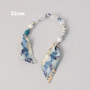 Detailed close-up of 32cm silk scarf and beaded handle strap with metal clasps