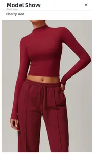 Detail of cherry red tight-fit mock neck yoga top and matching jogger pants set