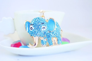 Macro shot of blue rhinestone-encrusted elephant keychain with gold detailing