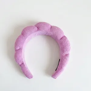 Detailed texture of purple twisted sponge headband made of soft terry cloth material