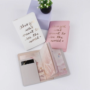 Three-color PU leather passport covers in white, pink, and gray with golden slogans