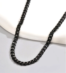 Detailed view of black stainless steel Cuban link chain with smooth metallic texture