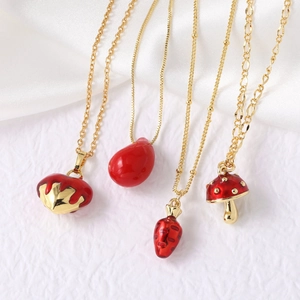 Detailed macro view of four red drip oil strawberry and mushroom gold plated pendants