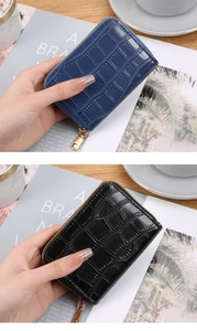 Detail of mini crocodile pattern card holders in navy and black with metal zippers