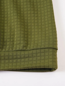 Macro shot of olive green waffle knit texture and stitching details on hoodie cuff