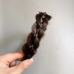 Detail view of deep brown fishtail braided headband with textured synthetic hair finish