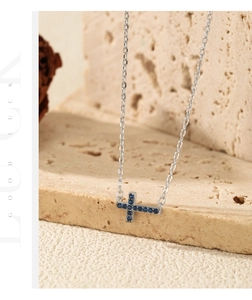 Close-up of S925 silver cross necklace featuring horizontal blue zircon stones
