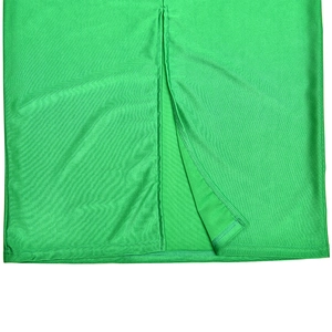 Detailed close-up of the high-slit hem on a sexy green dress with shiny fabric texture