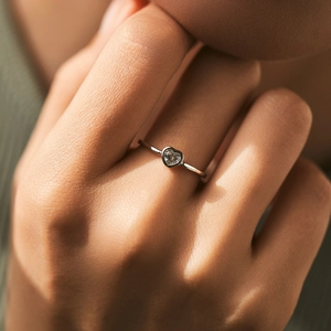 Minimalist S925 silver heart shaped moissanite ring worn on finger with elegant style