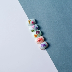 Detailed view of 5D colorful 3D embossed cartoon monster nail art stickers on fake nails