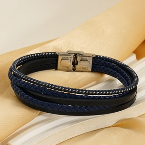 Close-up of multilayer braided leather bracelet with engraved stainless steel clasp