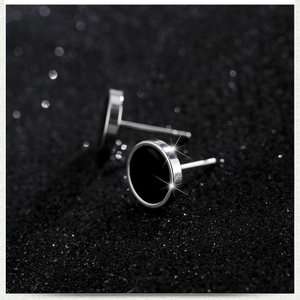 Minimalist black cat eye opal barbell studs in stainless steel with a metallic finish