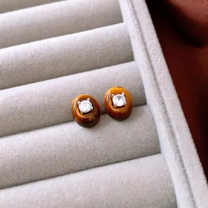 Oval tiger eye stud earrings with center zircon stone in a vintage gold finish