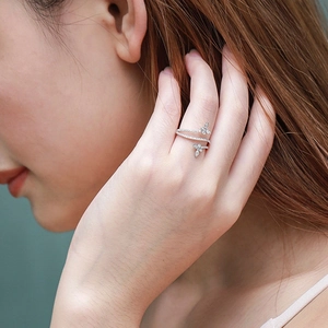 Elegant silver butterfly wrap ring with floral stone setting worn by a model