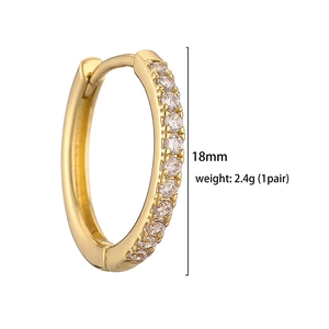 Detail view of 18mm gold huggie earrings with clear cubic zirconia micro-pave setting