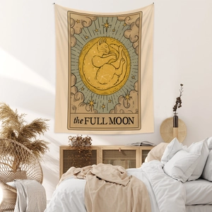 Cozy bedroom scene showing a Full Moon tarot style tapestry with a cat and stars