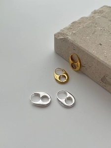 Macro view of minimalist 925 sterling silver hoop earrings in gold and silver finishes