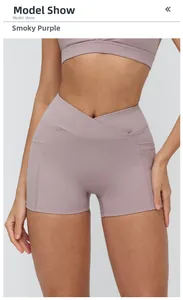 Detailed view of smoky purple yoga shorts featuring cross waist design and side pockets