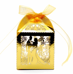 Detail of golden hollow candy box with Mr & Mrs laser cut silhouette and gold ribbon bow