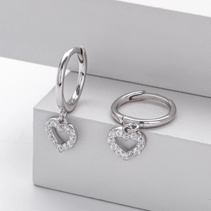 Macro view of S925 sterling silver hoop earrings with sparkling heart charms