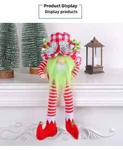 Detail of Christmas long-legged gnome with green beard and red checkered hat on fireplace
