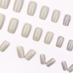 Short square press-on nails set in neutral khaki and silver glitter finish