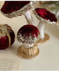 Detail of red velvet mushroom with gold glitter trim for vintage Christmas table decor