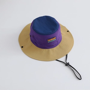 Detail of color-block hiking bucket hat with wide brim, drawstring and BETTER SELF label