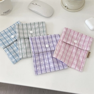 Flat lay of four pastel checkered sanitary storage bags in blue green purple and pink