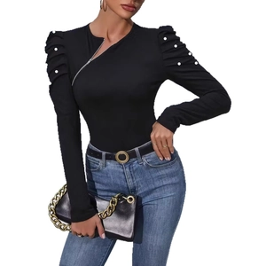 Detail of elegant black long sleeve top with pearl beads and asymmetric side zipper