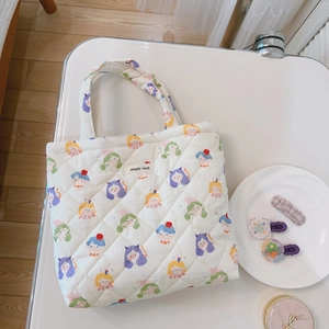 Macro shot of quilted floral tote with girl print pattern and simple wish woven label