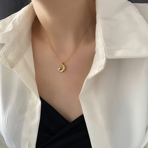 Minimalist gold titanium crescent moon necklace with zircon stone on elegant model