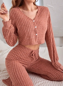 Detail of ribbed knit loungewear set in dusty rose featuring buttoned V-neck cardigan