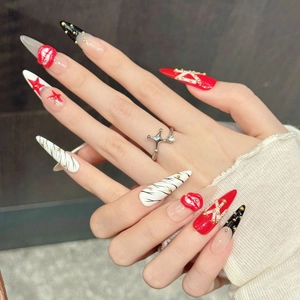 Star pattern and red lip relief on long stiletto press-on nails in red black and white
