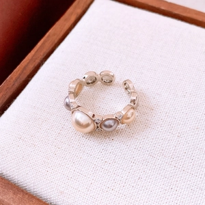 Macro shot of an adjustable pearl ring with sparkling zircon in vintage French style