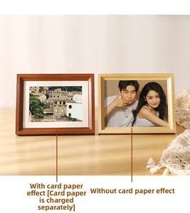 Detail of wooden picture frames with and without white matting against a sunny wall