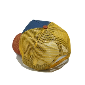 Detail of adjustable snapback closure on mesh trucker hat with blue and yellow panels