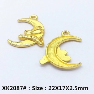 Detailed view of hollow gold moon charms with rabbit and cloud motifs for DIY jewelry