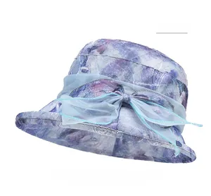 Detail of the sun hat showing elegant light blue organza bow and floral texture