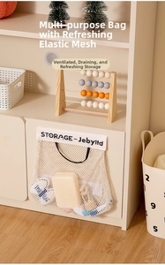 Close-up of beige wall-mounted mesh storage bag with elastic mesh and canvas top