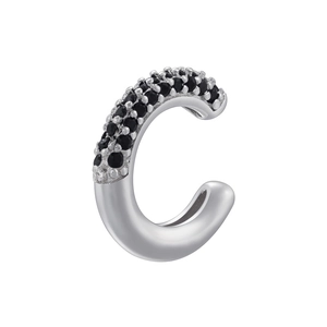 Macro shot of silver C-shaped ear cuff featuring black zircon pavé and polished metal