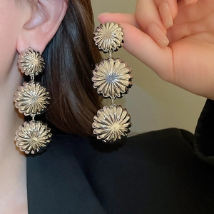 Silver metallic tiered flower earrings shown on model with polished vintage finish