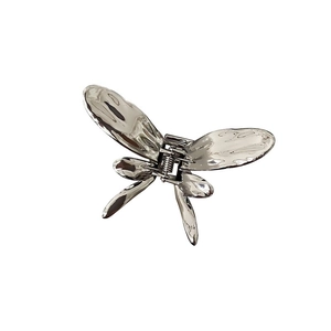 Silver liquid metal butterfly hair claw clip with a glossy lava texture on white background