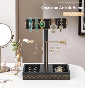 Detail view of T-bar jewelry stand with black velvet rods and gold metal arrow accents