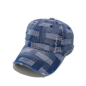 Detailed view of checkered patchwork denim baseball cap with distressed frayed edge details